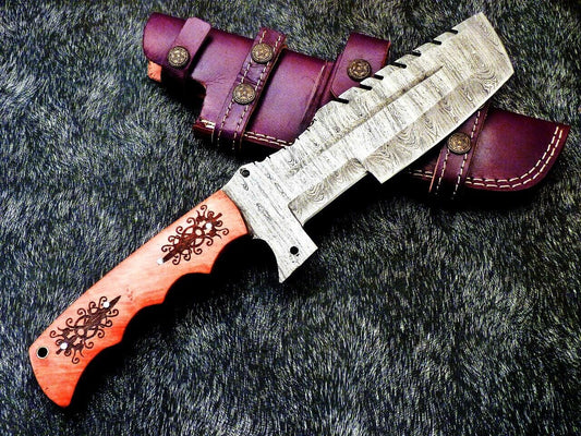 Sawback spine with deep notches and a long center fuller on the Damascus tracker blade