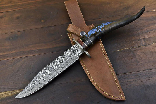 Damascus bowie blade with bold swirling layered pattern and clip point