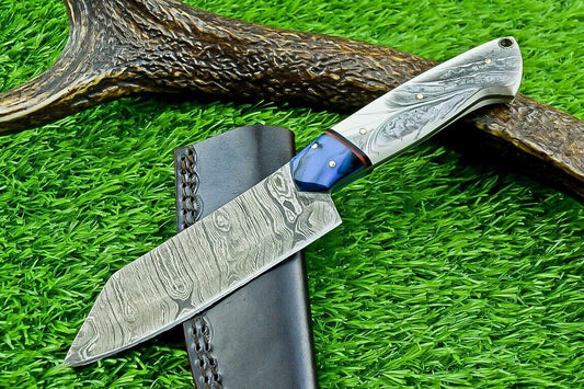 Wide Damascus skinner blade with straight edge, angled tip and bold layered pattern