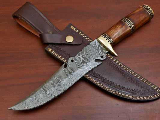 Close up of gut hook and cutouts on Damascus steel blade spine